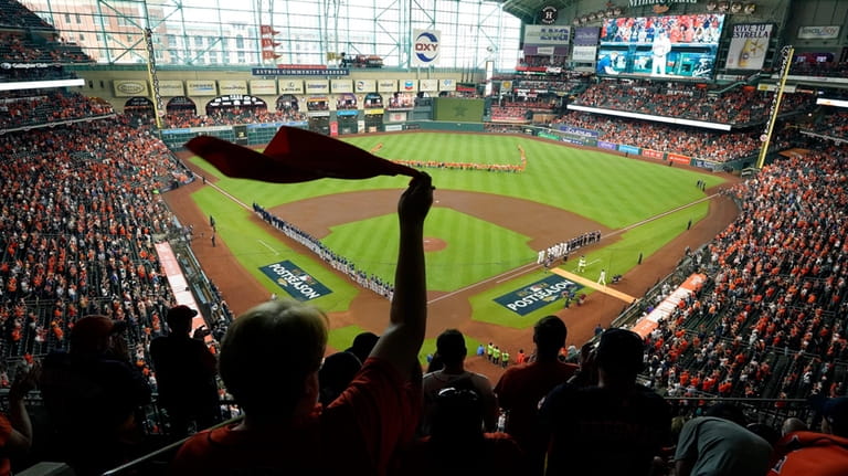 Fan cheer as the Houston Astros and the Seattle Mariners...