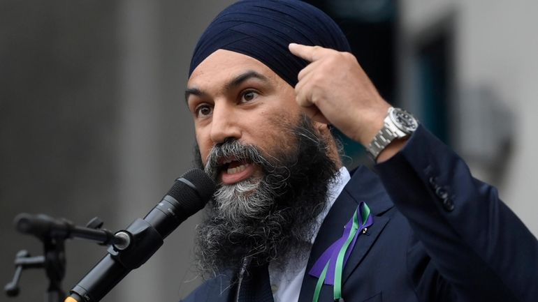 New Democratic Party leader Jagmeet Singh points to his turban...