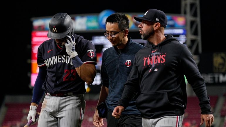 Minnesota Twins' Royce Lewis (23) walks to the dugout after...