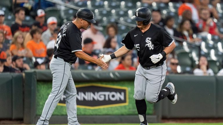 Chicago White Sox's Andrew Vaughn (25) celebrates with third base...