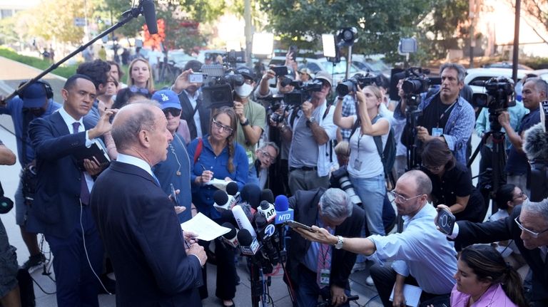 Abbe Lowell, left, an attorney for Hunter Biden, makes a...