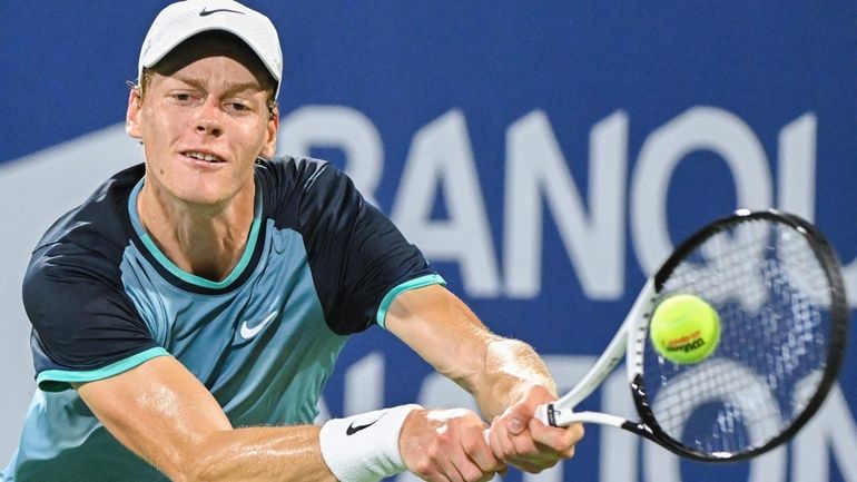 Jannik Sinner, of Italy, plays a shot to Andrey Rublev,...