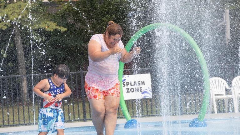 Sandra Barilla and son, Anthony, of Brentwood, play in the...