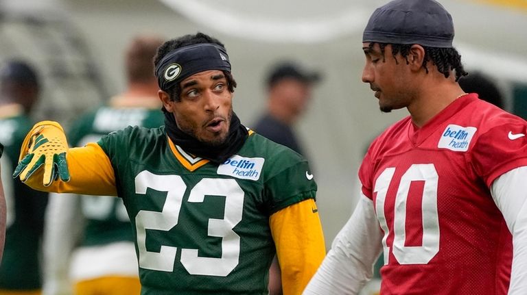 Green Bay Packers' Jaire Alexander talkls to Jordan Love during...