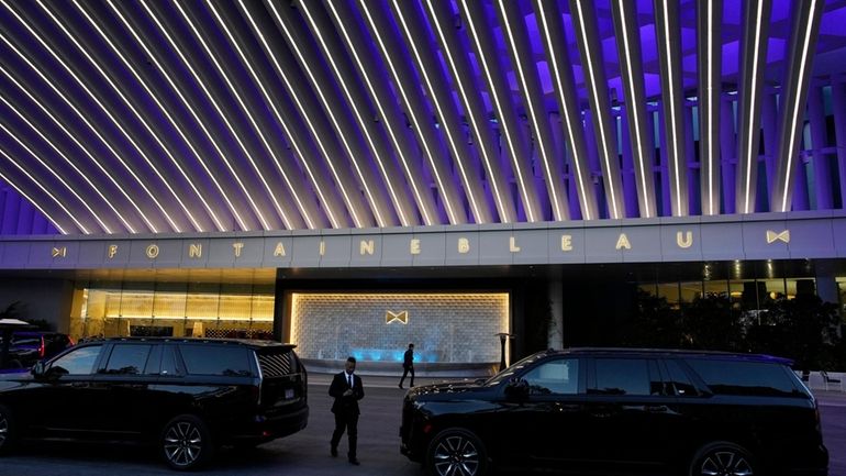 A driver walks to his car in the porte cochere...