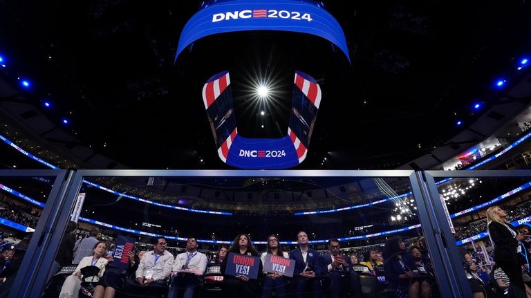 Delegates watch during the Democratic National Convention Monday, Aug. 19,...