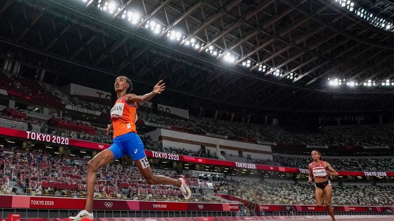 Sifan Hassan, of the Netherlands, wins the women's 10,000-meter run...