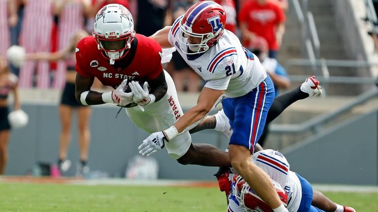 North Carolina State's Dacari Collins (4) is brought down after...