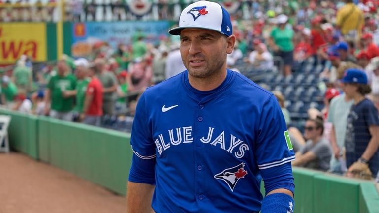 Toronto Blue Jays' Joey Votto walks to the dugout before...