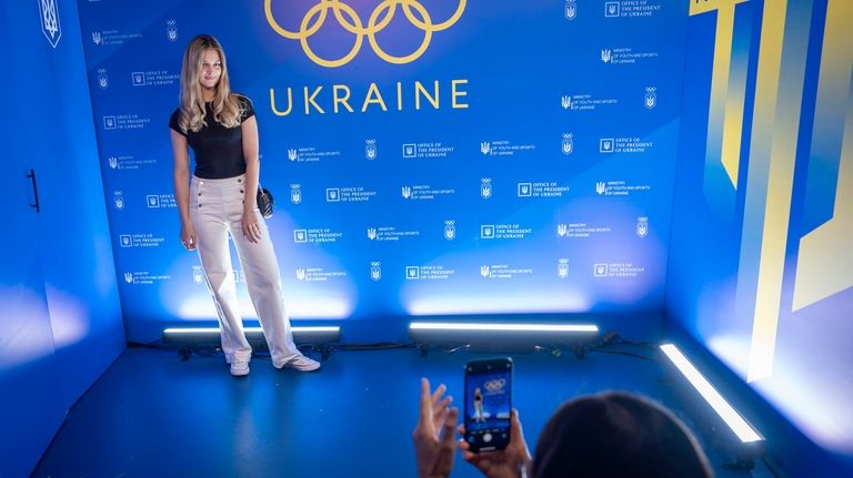 A woman poses for a photo ahead of the opening...