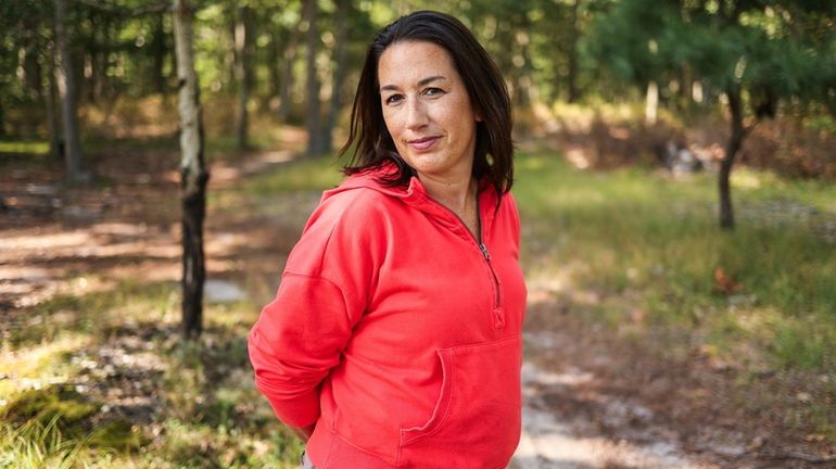 Breast cancer survivor Crystal Reiner, 46, of Hampton Bays, behind...