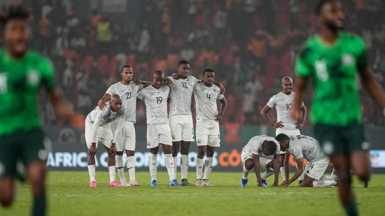 South Africa's players are dejected after losing the penalty shootout...