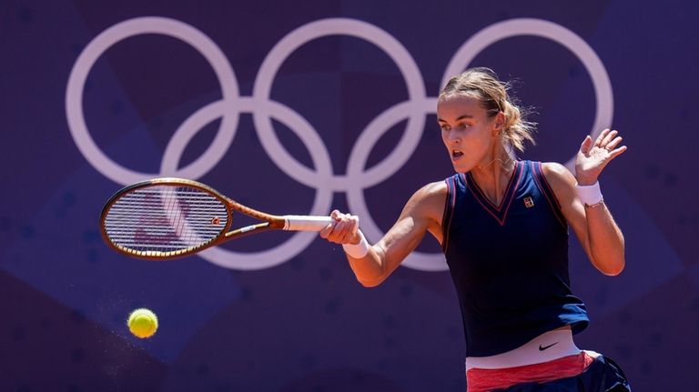 Anna Karolina Schmiedlova of Slovakia returns the ball against Barbora...