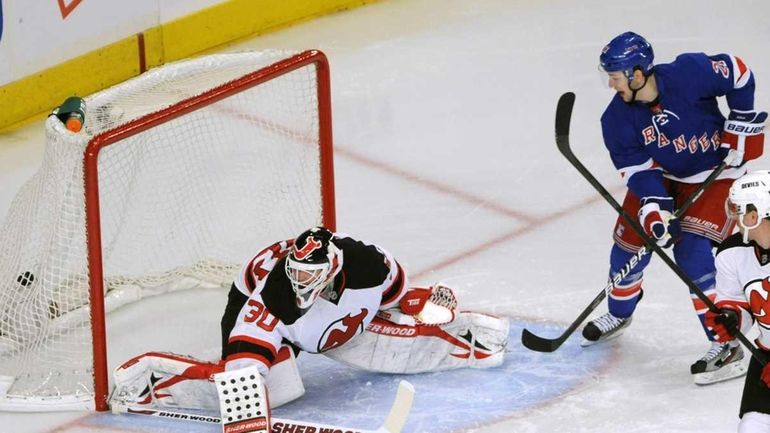 New York Rangers' Derek Stepan, right, watches a goal by...