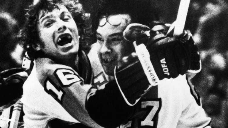 Philadelphia Flyers Bobby Clarke, left, hugs teammate Reggie Leach seconds...