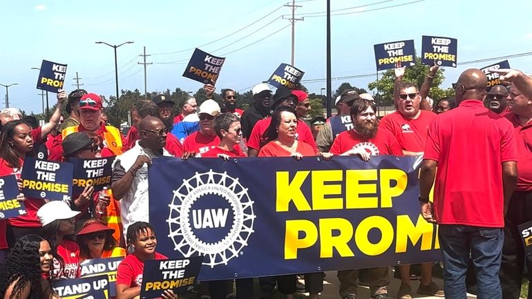 In this image from video, United Auto Workers members rally...