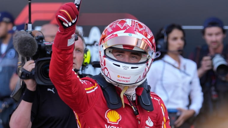 Ferrari driver Charles Leclerc of Monaco celebrates his pole position...