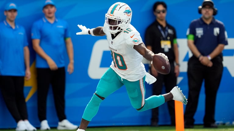 Miami Dolphins wide receiver Tyreek Hill celebrates his touchdown catch...