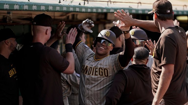 San Diego Padres' Juan Soto, center, celebrates with teammates in...