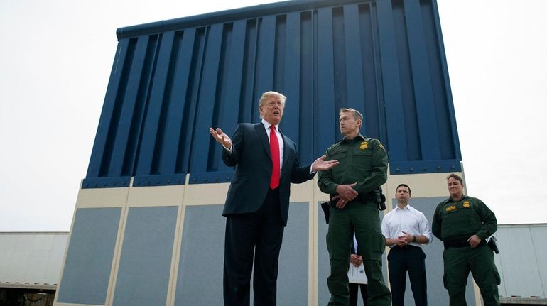 President Donald Trump talks with reporters on March 13, 2018,...