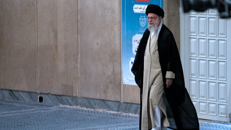 Iranian Supreme Leader Ayatollah Ali Khamenei arrives to vote for...