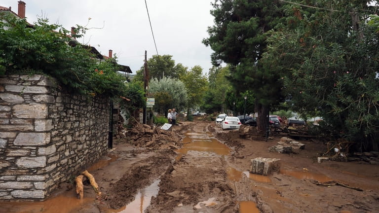 Mud covers a road after a record rainfall in Milina...