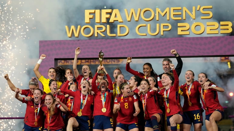 Team Spain celebrates after winning the Women's World Cup soccer...