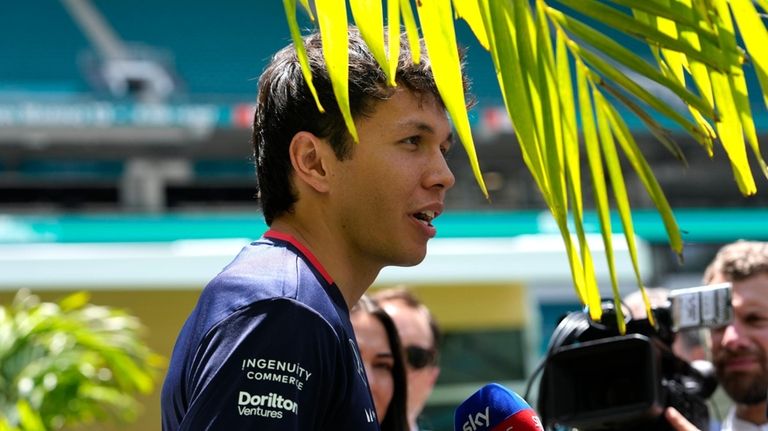 Williams driver Alexander Albon, of Thailand, talks with the news...