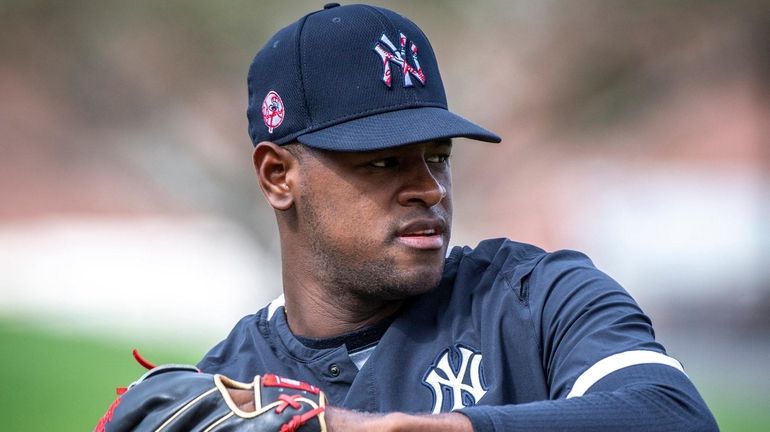 Yankees' pitcher Luis Severino warming up his arm for practice...