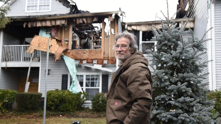 James Mecca surveys damage to his apartment on Saturday, a...