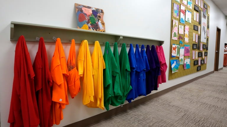 Students' smocks hang in a remodeled hallway in The Covenant...