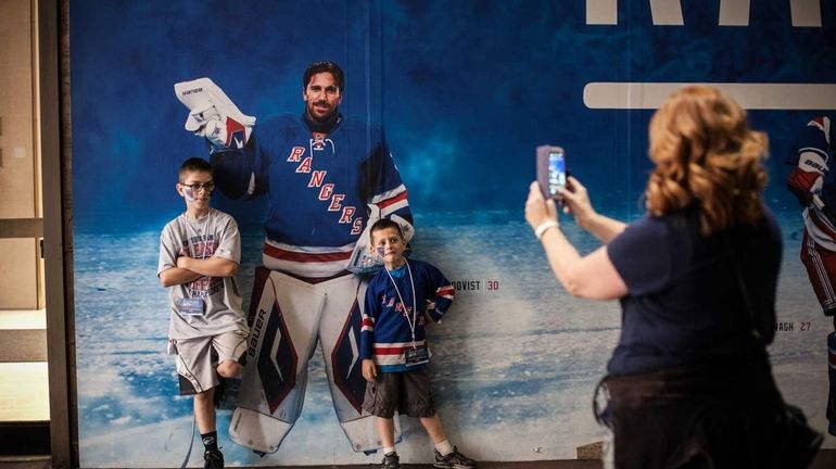 11-year-old Dylan and 7-year-old Logan Schroeder pose in front of...