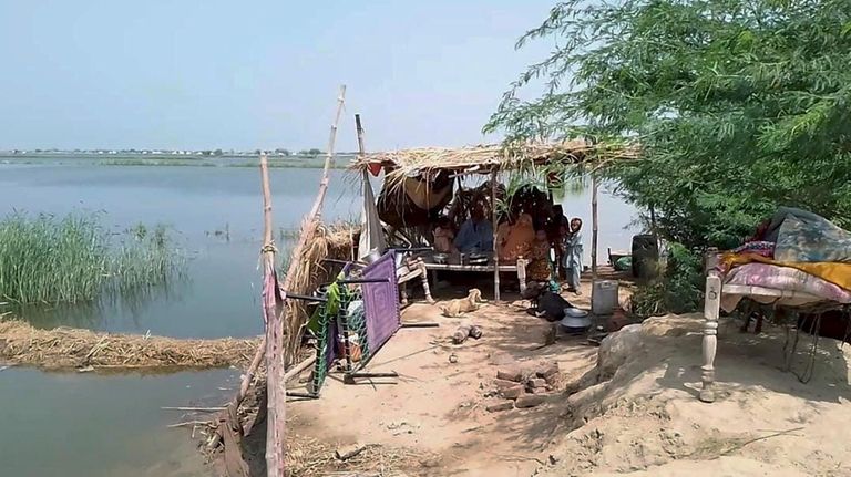 A family take refuge on high place after flooding their...