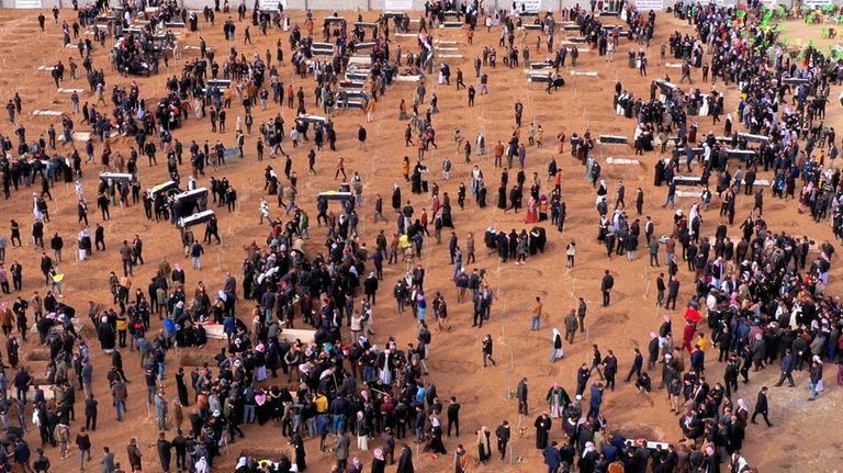 An aerial view of mourners preparing to bury the remains...