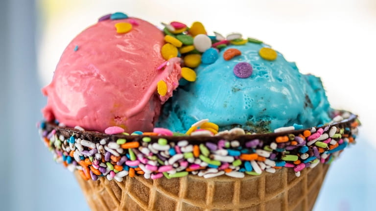Cotton candy and cookie monster-flavored ice cream is served at...