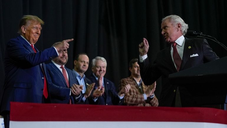 Republican presidential candidate former President Donald Trump, left, pointing to...