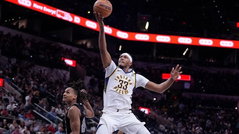 Indiana Pacers center Myles Turner (33) scores past San Antonio...