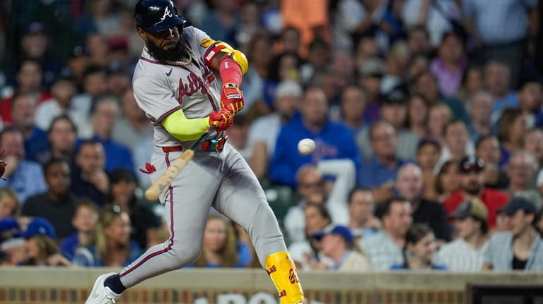 Atlanta Braves designated hitter Marcell Ozuna hits a three-run home...