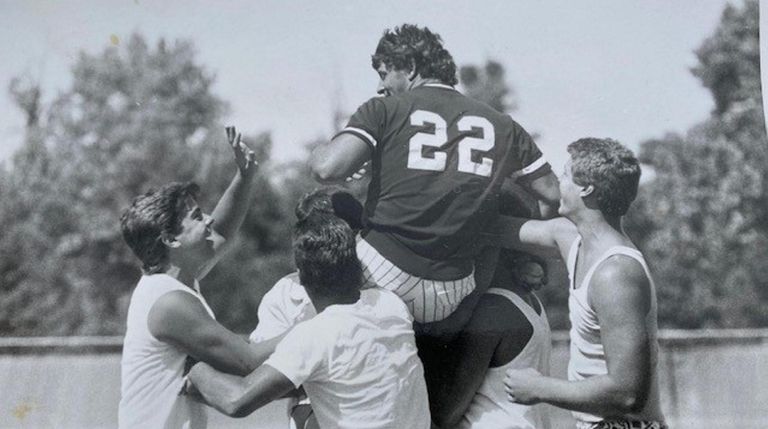 Connetquot's Rob DiLello is carried from field by his friends...