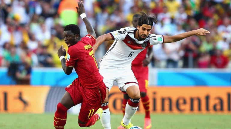 Sami Khedira of Germany competes for the ball with Sulley...