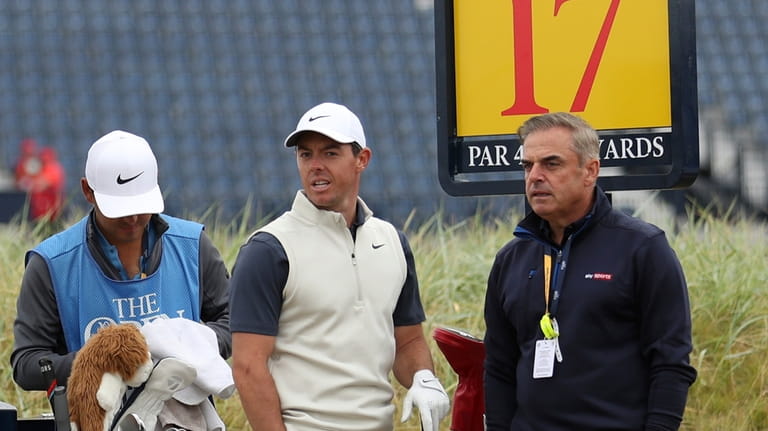 Rory McIlroy, of Northern Ireland, talks to Paul McGinley, right,...