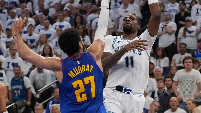 Minnesota Timberwolves center Naz Reid (11) shoots over Denver Nuggets...