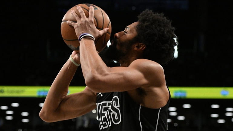 Nets guard Spencer Dinwiddie lines up his three-point shot against...