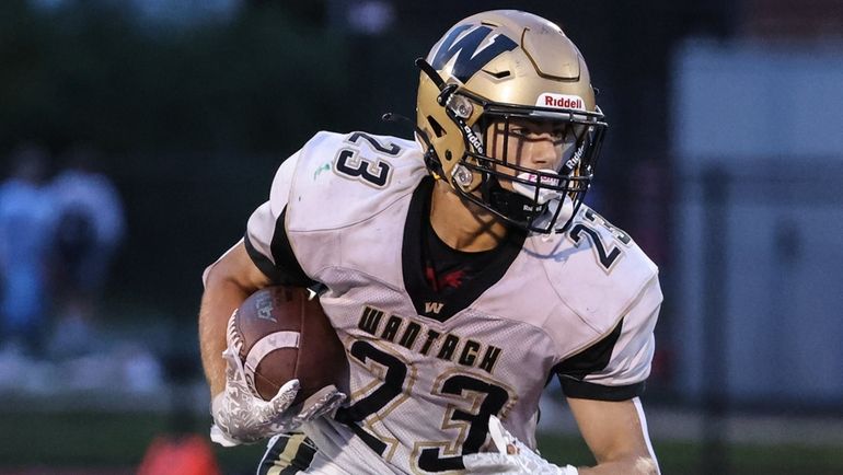 Dylan Martini of Wantagh looks for some extra yardage during...