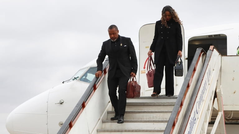 Malawi Vice President Saulos Chilima,left, and his wife Mary disembark...