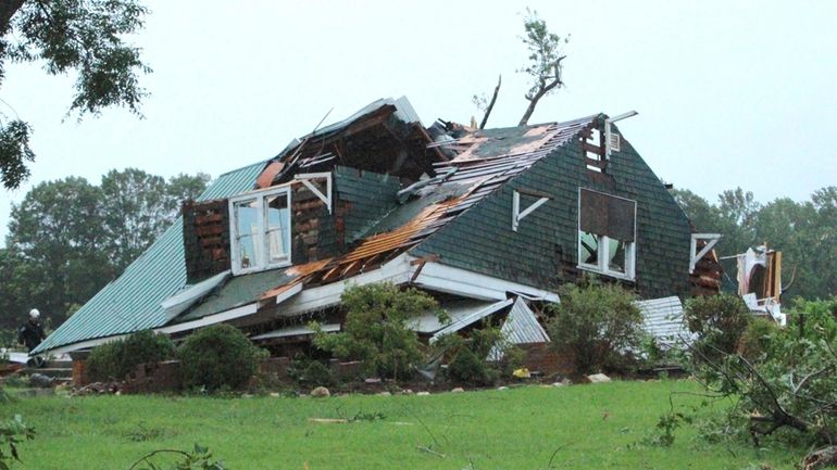 A house is damaged by a tornado spawned by Tropical...