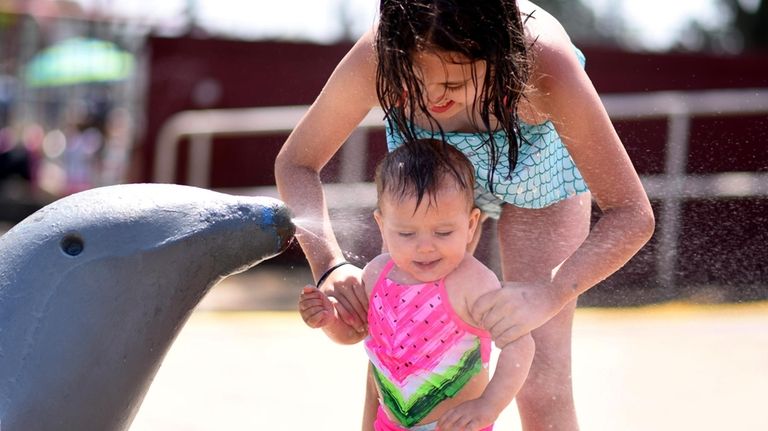 Sara Matijevic splashes with her sister Ema at Shell Creek...