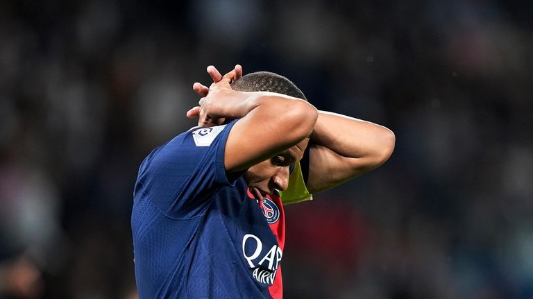 PSG's Kylian Mbappe reacts after missing a scoring chance during...