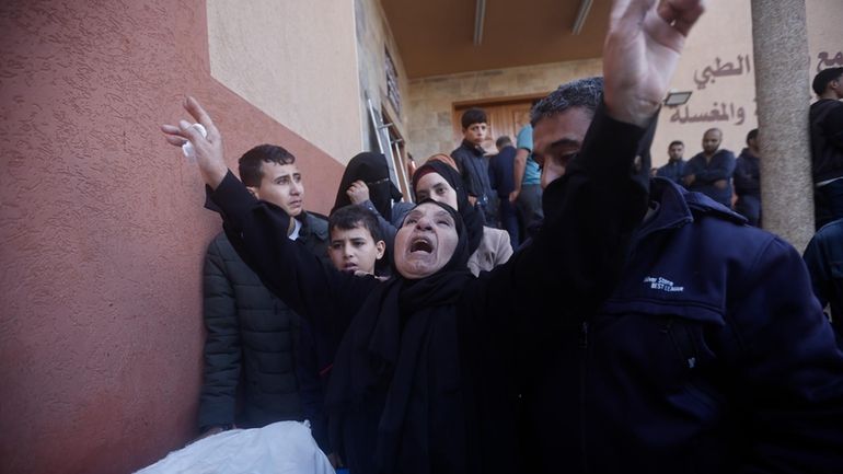 Palestinians attend a funeral of their relatives killed in the...