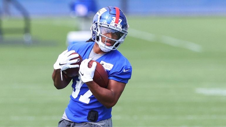 Gary Brightwell #37 of the Giants runs drills during mini camp...